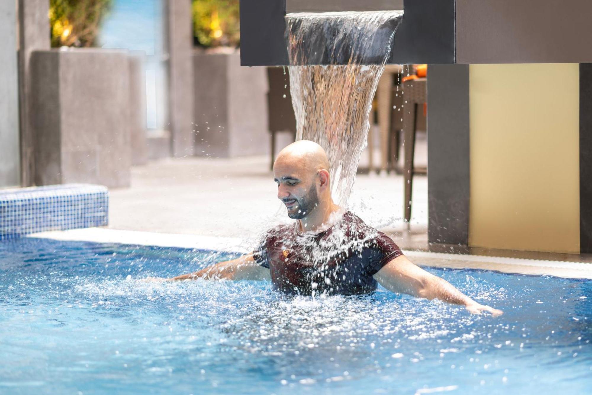 Delta Hotels By Marriott City Center Doha Exterior photo A man swimming in a pool