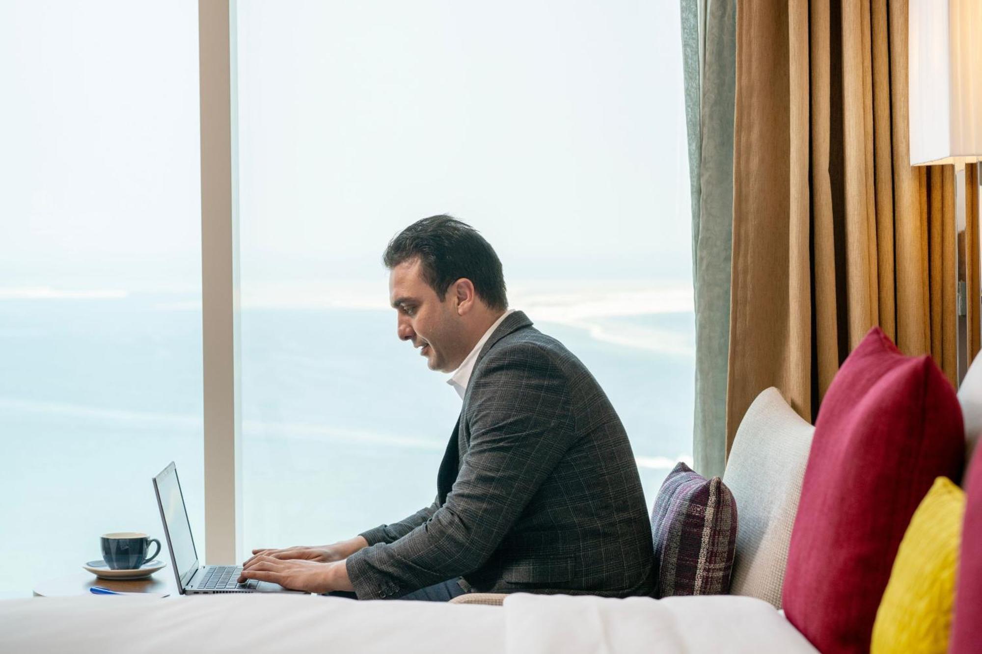 Delta Hotels By Marriott City Center Doha Exterior photo A businessman working on a laptop