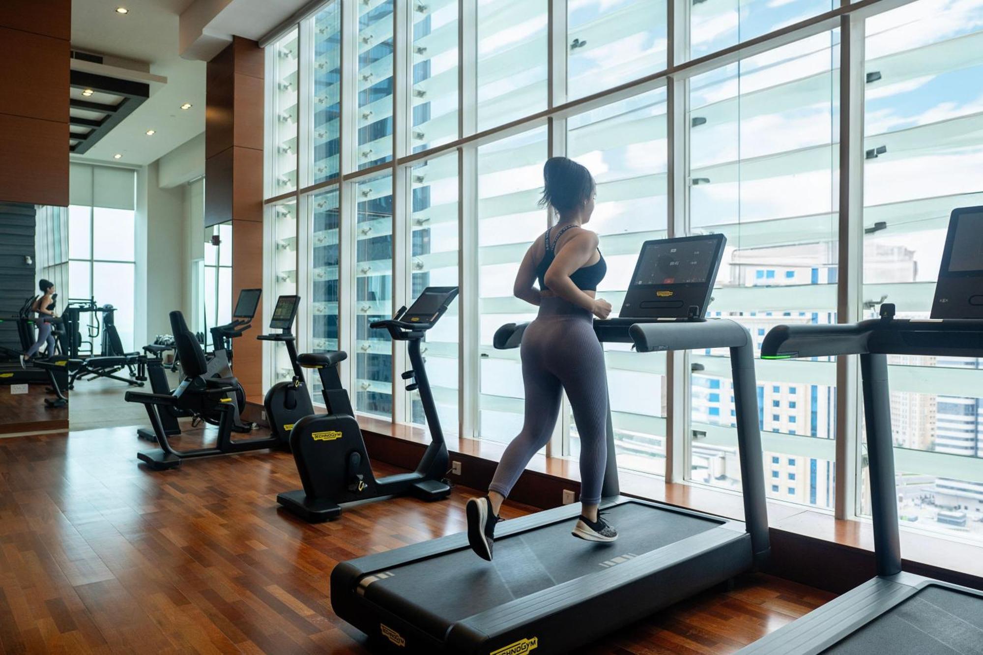 Delta Hotels By Marriott City Center Doha Exterior photo A woman exercising on a treadmill