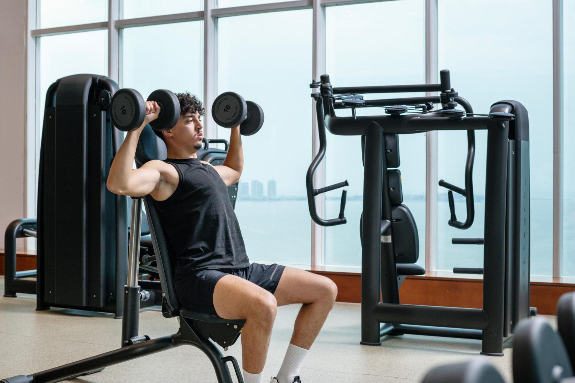 Delta Hotels By Marriott City Center Doha Exterior photo A man lifting weights